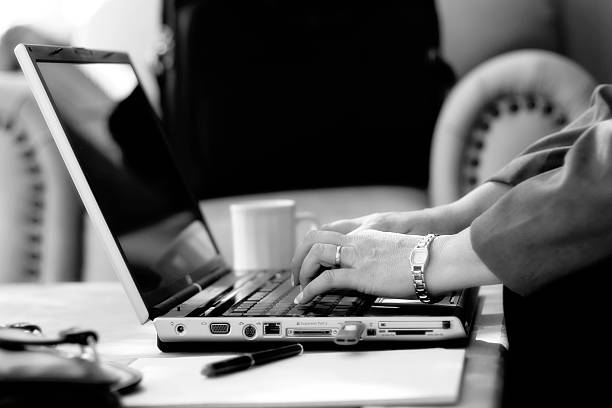 istock Businesswoman Typing in Hotel Atrium (BW) 471029177