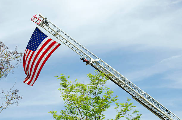 istock American Flag Hanging from a the Boom of a Fire Engine 471031762