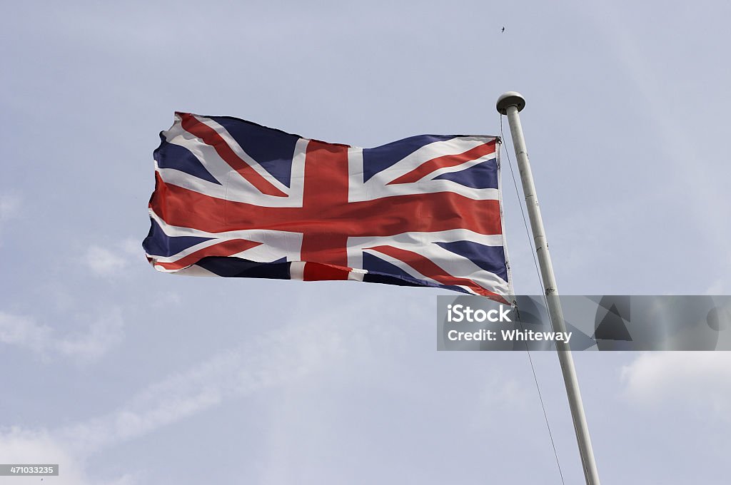 Flying the flag for Britain Union Jack Union Jack flag flying for Britain. The UK flag consists of three elements: the cross of St. George (red on white) for England, the cross of St. Andrew (white diagonal on blue) for Scotland, and the 'cross of St. Patrick' (red diagonal on white) for Ireland. The original Union Jack / Union Flag, adopted in 1606, was symmetrical. The red cross of St. George was outlined in white overlaid on top of a St. Andrew's flag, which was blue with a white X. In 1801, an Act of Union which made Ireland a co-equal member of the United Kingdom made it necessary to add a symbol for Ireland to the flag. Arts Culture and Entertainment Stock Photo