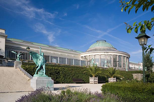 Park with botanical garden greenhouse, Brussels View of the "Botanique" or "Kruidentuin": the botanical garden greenhouse in Brussels. It dates from 1796, right after the French Revolution. Now used as a gallery and event host. greenhouse in botanical garden brussels stock pictures, royalty-free photos & images