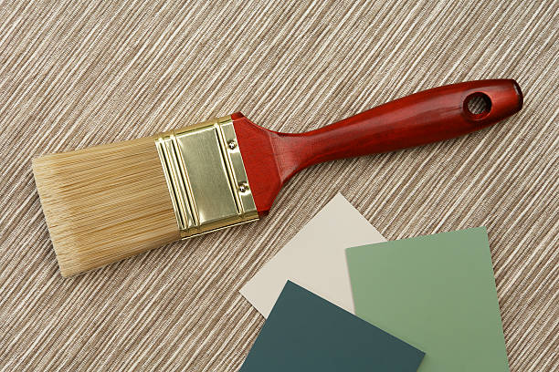 Paint brush and samples on natural texture stock photo