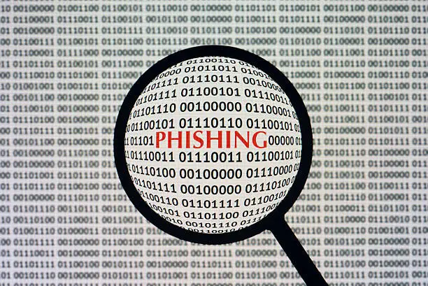 Photo of Phishing loupe and binary code computer screen