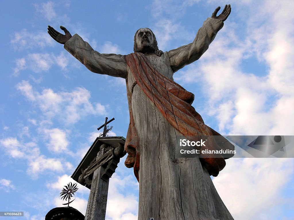Jesus is here One of hundreds of religious images at the pilgrimage landmark site "Hill of Crosses" in Siauliai, Lithuania. Sculptures, rosaries, crucifixes, etc, are devotedly left there in retribution for reached graces. It's an open air attraction for tourists and pilgrims. Catholicism Stock Photo
