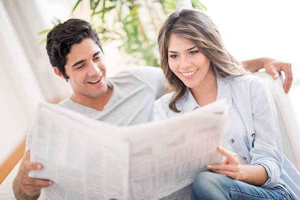istock Couple reading the newspaper at home 471035052