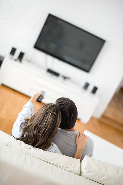 istock Couple relaxing watching television 471035082