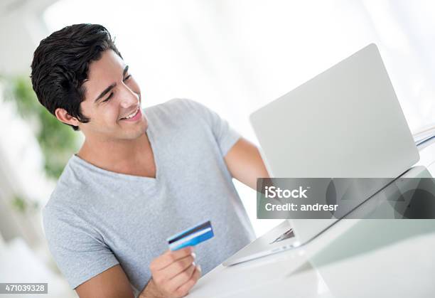 Man Shopping Online From Home Stock Photo - Download Image Now - Financial Bill, Internet, Latin American and Hispanic Ethnicity