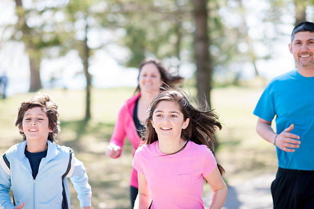 istock Family Jogging through Park 471040264