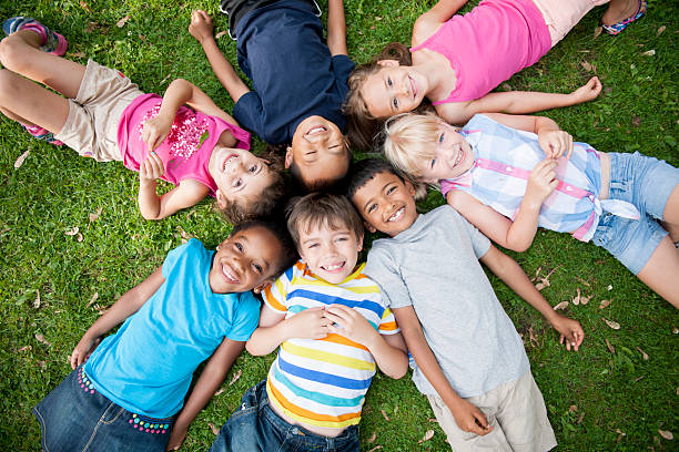 istock Children in Grass with Heads in Circle 471040392