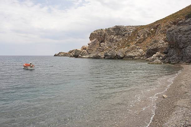 Boat in a bay A boat is anchored in a bay on Crete malerisch stock pictures, royalty-free photos & images