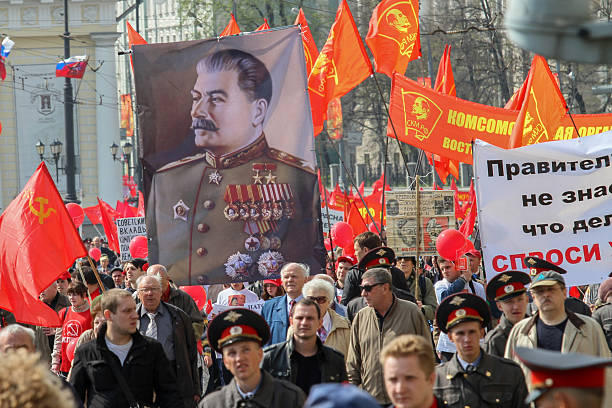 Celebration of May Day in the centre of Moscow. Moscow, Russia - May 1, 2010: During the celebration of May Day. Communist party supporters take part in a rally. (portrait of Soviet dictator Josef Stalin) vladimir russia stock pictures, royalty-free photos & images