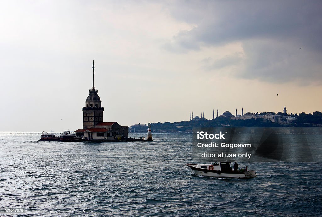 Maiden's Tower/ Kiz Kulesi Istanbul, Turkey - October 6, 2014: A small boat view with Maiden's Tower in Istanbul, It's one of the symbols of Turkey and there is a part of the Bosphorus at the background with people. Some of people visits the restaurant in tower. 2015 Stock Photo