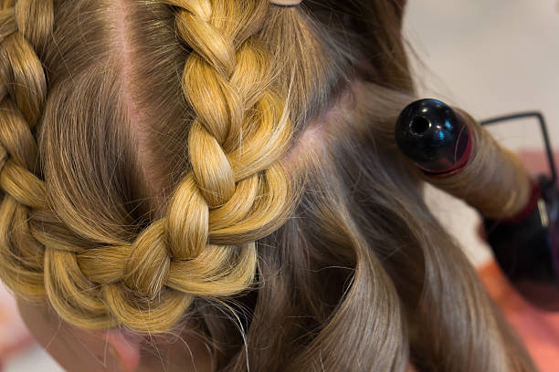 istock Hairdresser makes braids 471047826
