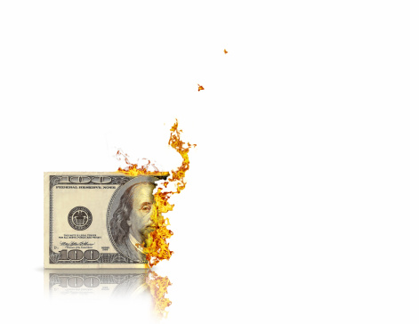 Image of $100 bill burning. Represents not spending but saving...