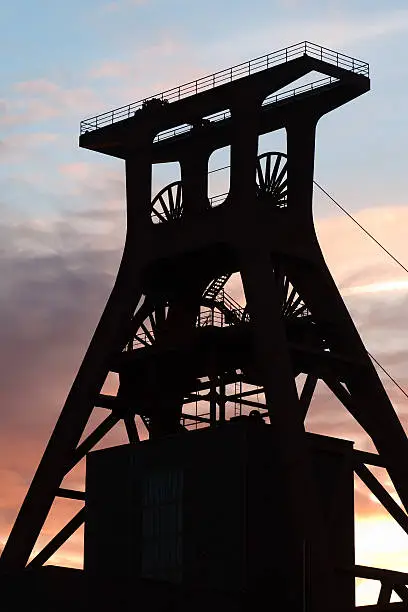 the famous shafttower of the "Zollverein mine" (with conveyor) wheels at sunset