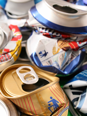 Closeup view of crushed cans. One of them has an iconic 