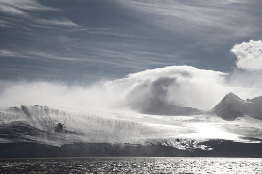 wind blowing over sunlit mountains - beautiful antarctic landscape