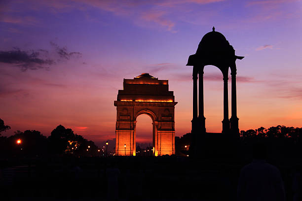 puerta de la india delhi, iluminado al atardecer paisaje - delhi fotografías e imágenes de stock