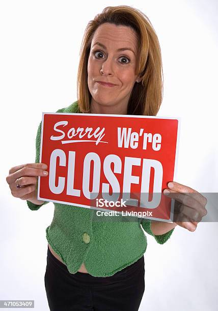 Young Woman Holds Up Sorry Were Closed Sign Stock Photo - Download Image Now - Adult, Adults Only, Closed Sign
