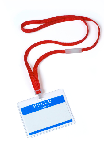 Name tag in plastic sleeve, with lanyard.   Isolated on white.  Name tag is preprinted with the words \
