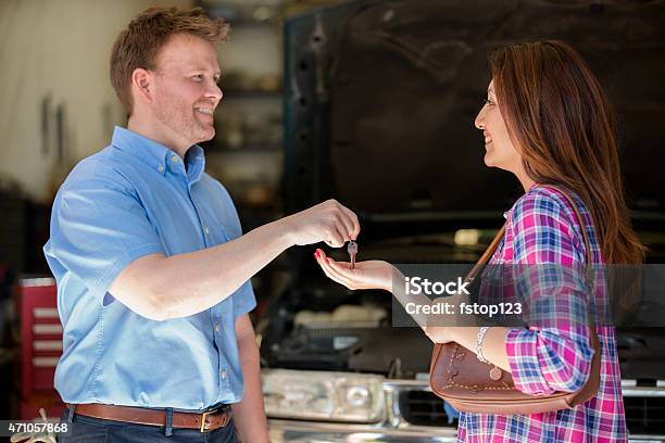 Happy Customer Gets Keys Satisfied With Auto Mechanics Great Service Stock Photo - Download Image Now