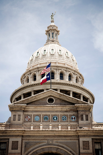 detail of the capitol building in austin texas with american an texan flag. from istockalypse austin, texas. 