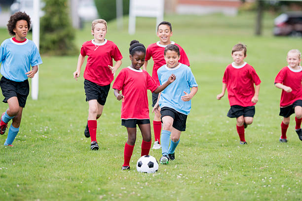 rincorrere il pallone da calcio - fitness goal foto e immagini stock