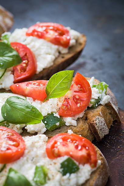 Bruschetta with tomato, basil, cottage cheese and bell pepper stock photo