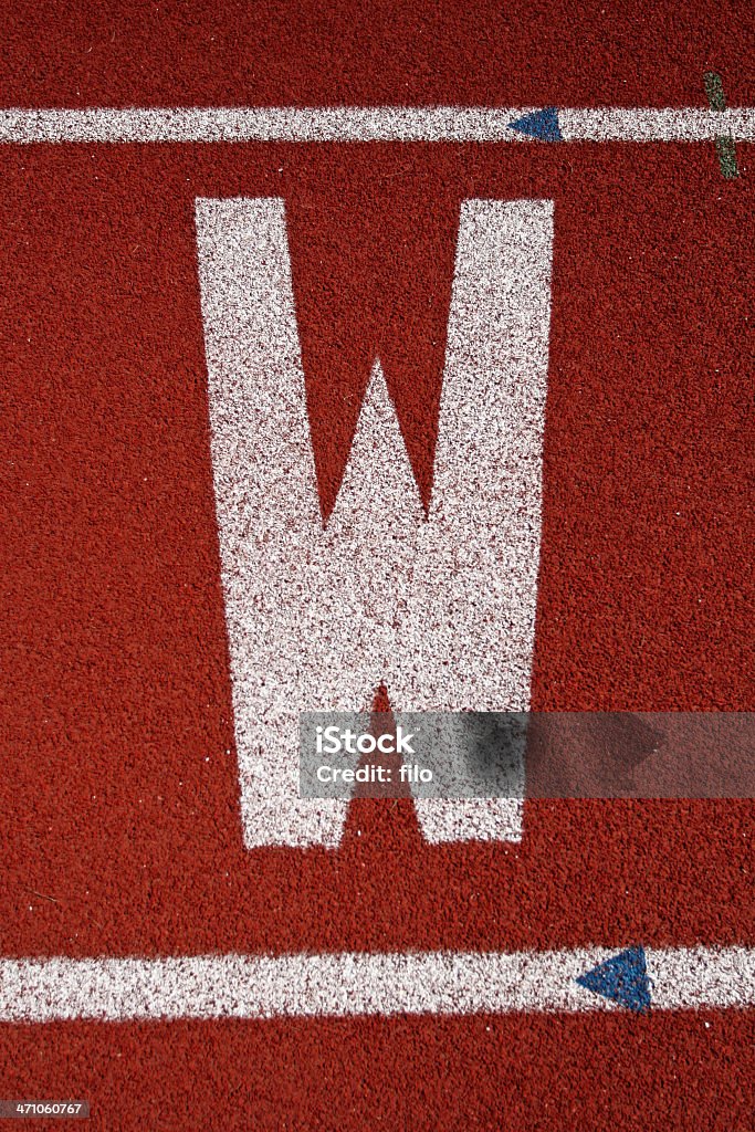 Letter "W" White letter "W" on a running track. Alphabet Stock Photo