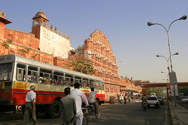 Busy Street Scene In Jaipur, India Traffic in front of Hawa Mahal, or the Palace of Winds, Rajasthan. hawa mahal photos stock pictures, royalty-free photos & images