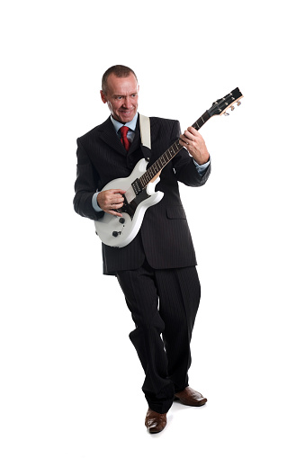 A senior man playing the electric guitar