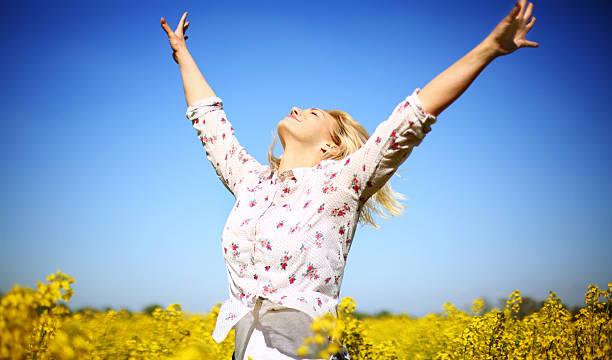 istock Happy woman in canola field. 471060862
