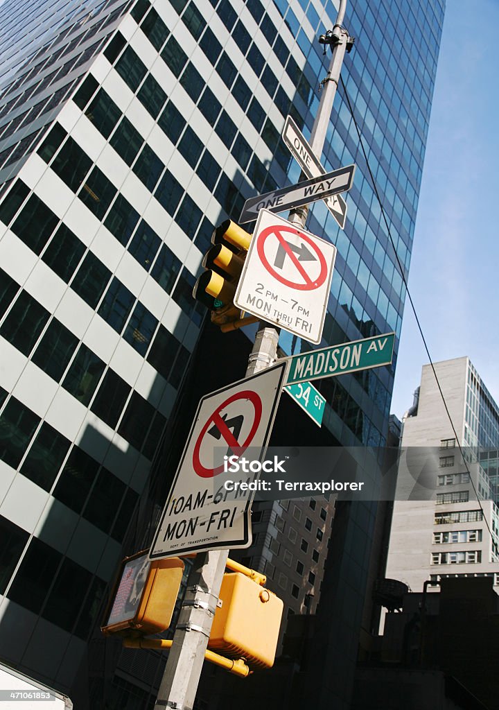 Street Signs On Madison Avenue Low angle view of sign boards on lamp post in Midtown Manhattan, New York City, Ny, USA. American Culture Stock Photo