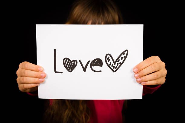 istock Child holding Love sign 471063186