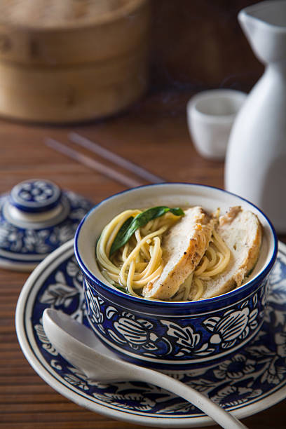 Bowl of Asian chicken noodle soup stock photo