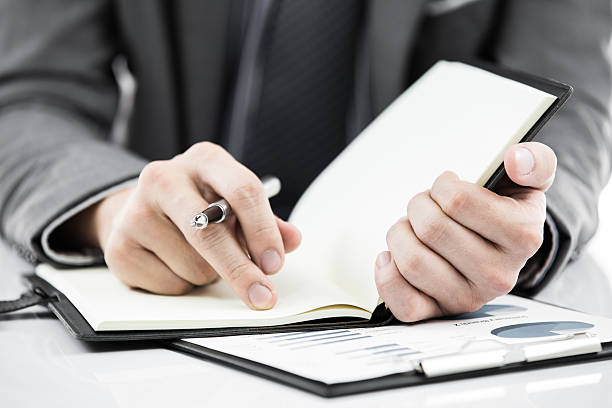 istock business report and man hand with pen 471064297