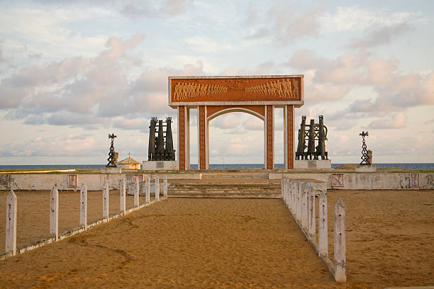 Benin: Slavery Memorial at the Portal of No Return, Ouidah  In the town of Ouidah on the Atlantic coast of west Africa in the small country of Benin, the national government (with the help of the United Nations) built the depicted public monument to commemorate the tragic history of slavery in the area.   benin stock pictures, royalty-free photos & images