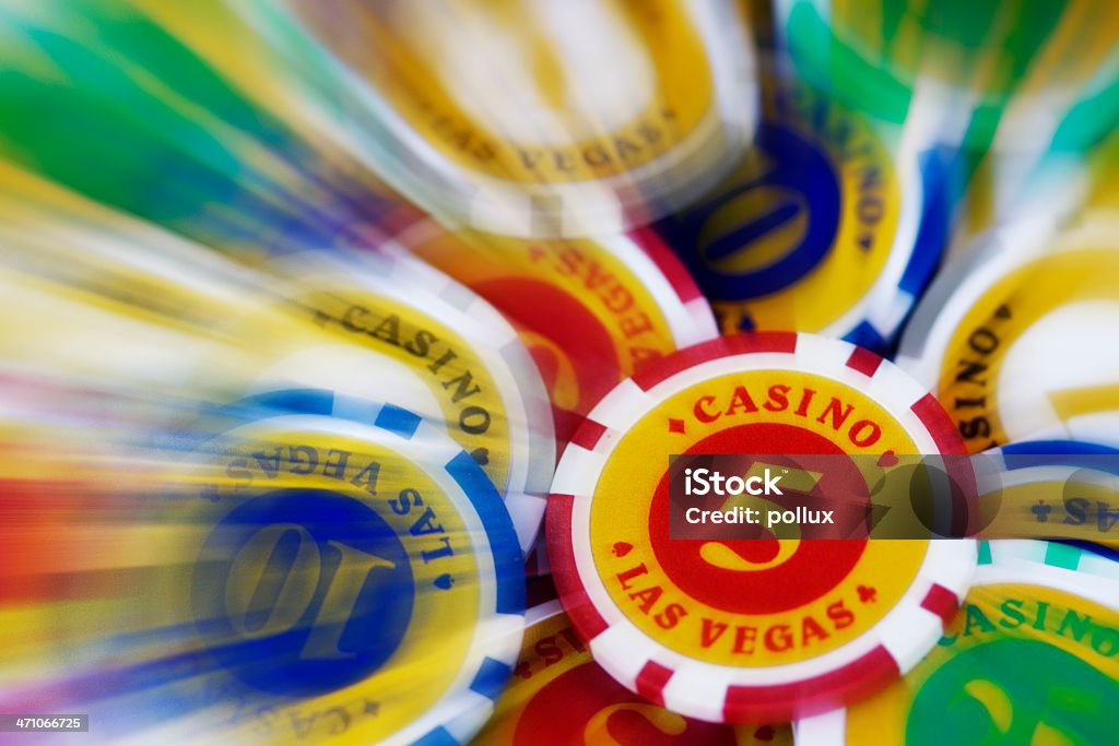 Bigger bet Zoom effect on plenty of poker chips (different value : 1, 5, 10, 25&#8230;) stamped "Casino &#8226; Las Vegas" Abundance Stock Photo
