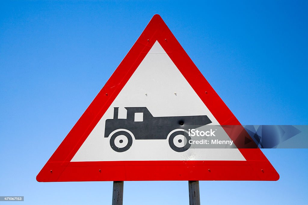 Danger Trucks Crossing Road Sign Series X Danger Trucks Crossing Road Sign against blue summer sky. Exotic Road Sign Series X. Advice Stock Photo