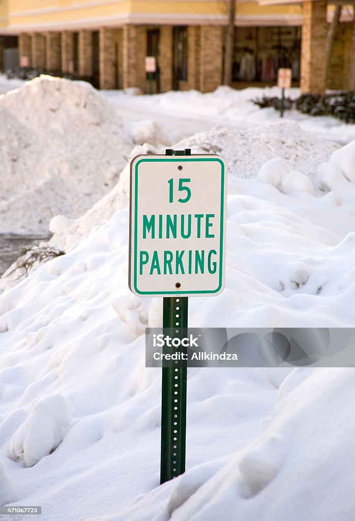 fifteen min parking a "15 minute parking" sing buried in the snow. Buried Stock Photo
