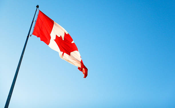 istock canadian flag waving on the sky 471068370