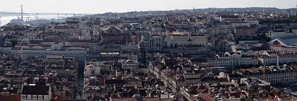 The town of Lisbon - Portugal. On the left part of the picture the old district of Baixa. In the rear, the suspension-bridge of "25th of April".