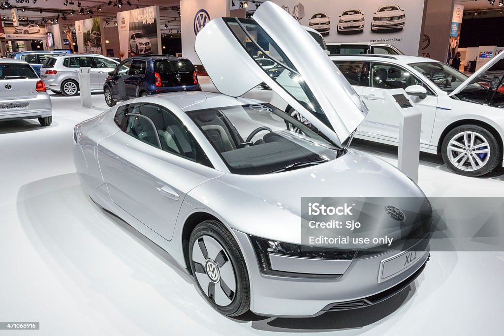 Volkswagen XL1 fuel efficient concept car Amsterdam, The Netherlands - April 16, 2015: Volkswagen XL1 fuel efficient concept car on display during the 2015 Amsterdam motor show. People in the background are looking at the cars. Car Dealership Stock Photo