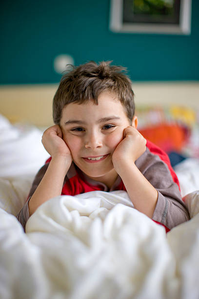 istock Young boy waking up with a bright smile 471070127