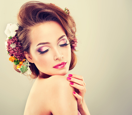 	Girl with delicate flowers in hair and fashion fuchsia nail