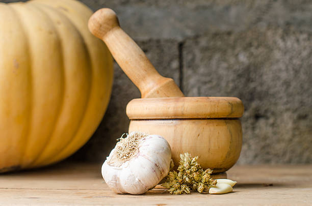 Rustic still life of aromatic herbs with a wooden mortar