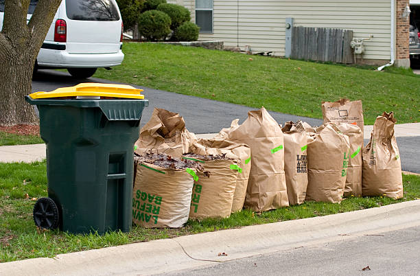yard waste bags three In Suburban Chicago Yard Waste has to be placed in "recycle" bags and special stickers paid in advance need to be placed on them in order for them to be picked up by the disposal service curb photos stock pictures, royalty-free photos & images