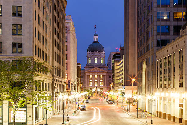 Indianapolis Morning Statehouse of Indiana in Indianapolis and Market Street lights at early morning from Monument Circle indianapolis photos stock pictures, royalty-free photos & images