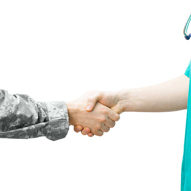 istock Soldier and doctor shaking hands on white background 471073868