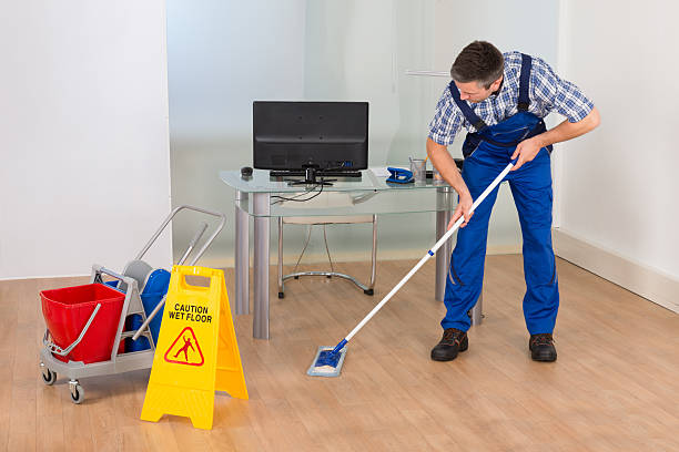 istock Man Mopping Office With Wet Floor Sign 471074394