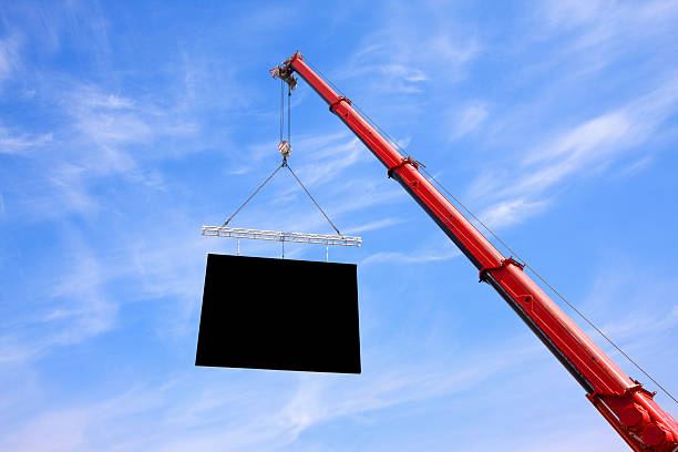 Crane lifting Flat Panel into Sky stock photo
